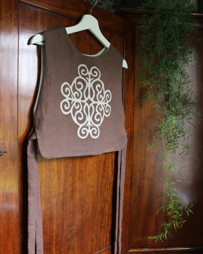 Coiling Medieval Relic on Brown Linen